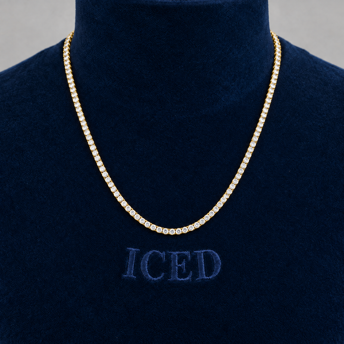 Gold moissanite tennis chain on Iced velvet bust