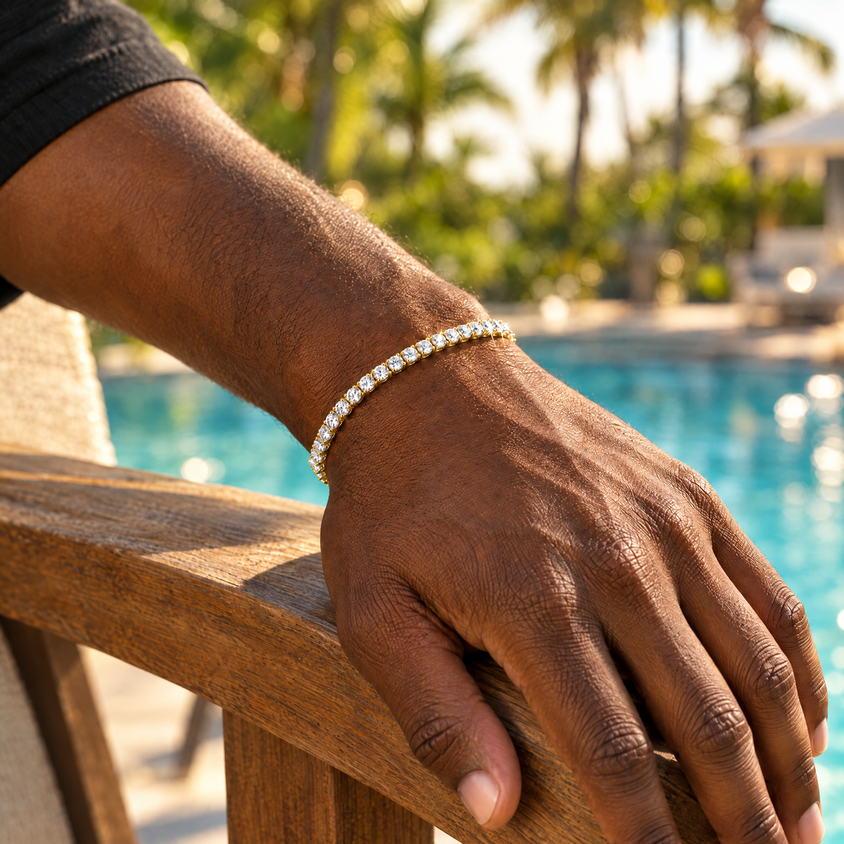 Gold moissanite tennis bracelet on wrist by the pool